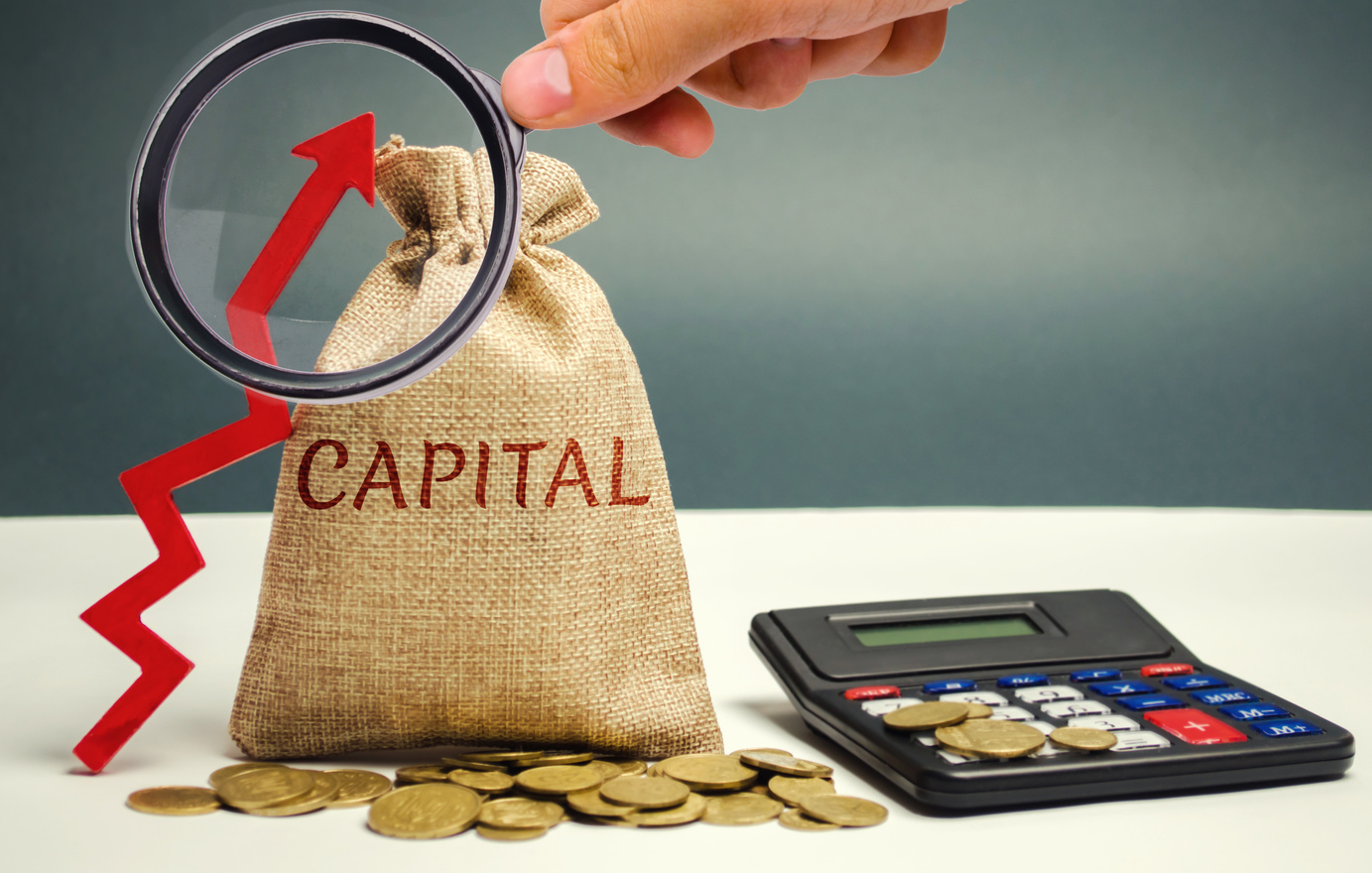 Money bag with the word Capital and an up arrow. The concept of accumulation and increase in money capital. Increase in capital gains taxes. Increase in the number value of the company's shares.